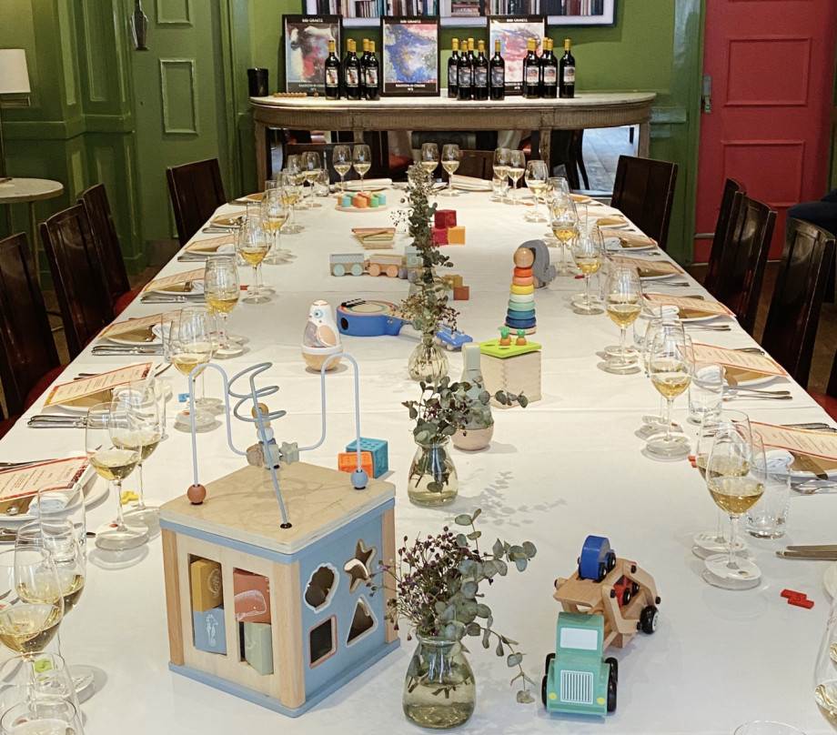 Formal dinner setting with children's toys as a centre piece